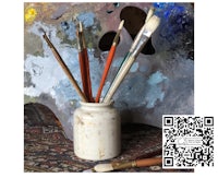 a jar of paint brushes with a qr code